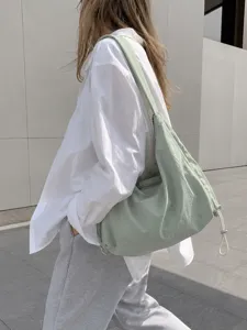 Light green nylon hobo shoulder bag detail showing large capacity and side drawstring.