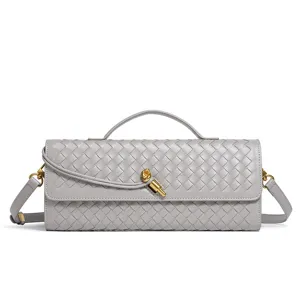 Detailed view of the woven leather shoulder bag showing intricate texture and golden hardware.