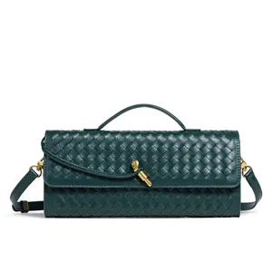Dark green woven leather shoulder bag detail, elegant intrecciato style handbag for women.