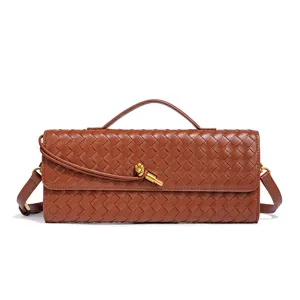 Brown leather woven baguette bag with top handle and metal knot accent, versatile crossbody.