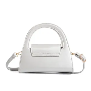 Silver semi-circular handbag detail shot, elegant solid color commuting retro design.