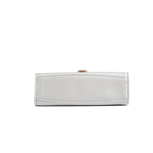 Light grey leather women handbag bottom detail shot, classic minimalist casual crossbody bag style.