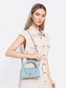 Women casual solid color half round crossbody bag with metal lock handle, stylish handbag.