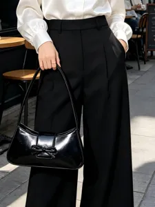Stylish black patent leather shoulder bag for women, chic minimalist baguette bag with bow.