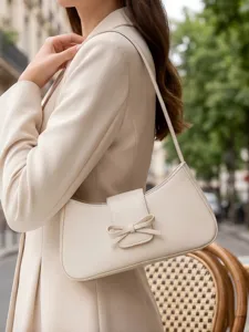 Minimalist beige baguette shoulder bag for women, elegant bow flap underarm handbag commute.