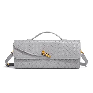 Detailed view of the stylish grey woven leather baguette bag showing fine intrecciato craftsmanship.
