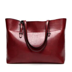 Wine red PU leather tote bag detail showing elegant craftsmanship and large capacity.