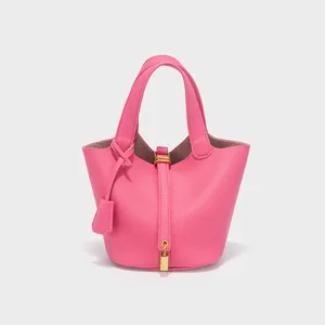 Pink pu leather bucket bag handbag detail, stylish design with metal lock closure and double handles.