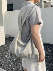 Casual minimalist nylon hobo shoulder bag with drawstring design, large capacity commuter tote.