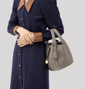 Grey PU leather bucket bag with top handles and padlock charm, stylish daily handbag for women.