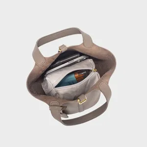 Top view detail of grey PU leather bucket bag interior capacity and removable pouch storage.