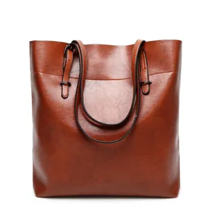 Brown leather tote bag detail view, classic shoulder handbag for women daily use.