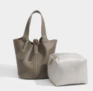 Minimalist PU leather bucket bag set with a stylish handbag and a chic pouch for women.