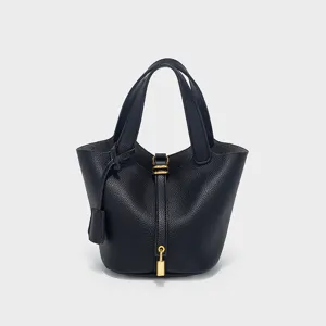Classic black PU leather bucket handbag detail, elegant top handle design with lock closure.