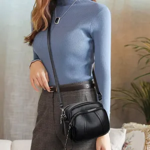 Women's black soft leather crossbody bag fashion shoulder bag with multi zippers.