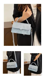 Detailed view of the light blue handbag showcasing its marbled texture and front flap design.