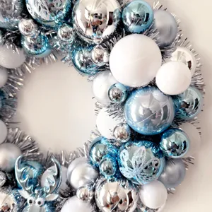 Weihnachtskranz Dekoration mit blauen silbernen und weißen Kugeln für die weihnachtliche Tür.