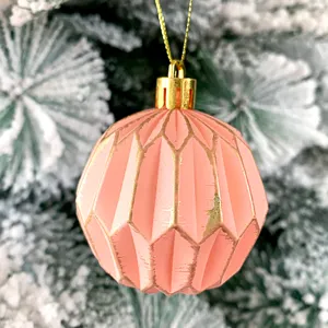 Detailansicht der retro rosa rissigen Weihnachtsbaumkugel mit goldenen Linien.