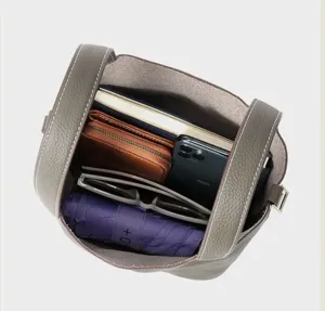Detailed view of grey leather bucket bag interior showcasing spacious capacity and storage.