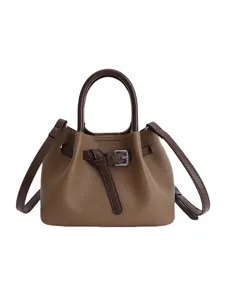 Brown leather bucket bag with top handle and stylish front knot belt design for women.