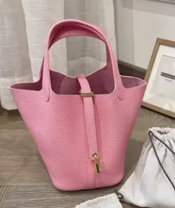 Pink PU leather bucket handbag, stylish versatile tote bag with lock detail for women.