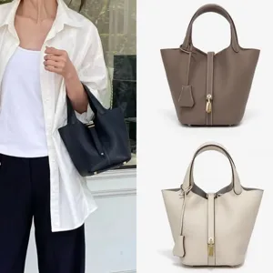 Detailed close-up view of stylish PU leather bucket bag with metal lock and durable handle.
