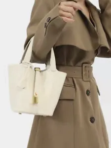 Minimalist PU leather bucket handbag with lock closure for women, stylish daily tote bag.