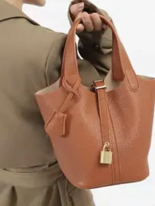 Stylish brown PU leather bucket handbag with metal lock, minimalist design for women.