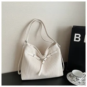 Minimalist pleated shoulder bag for women, stylish white leather tote with spacious interior.