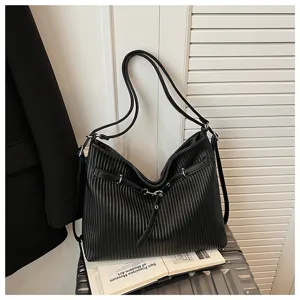 Black leather pleated tote bag for women, stylish commuter shoulder bag with chic design.