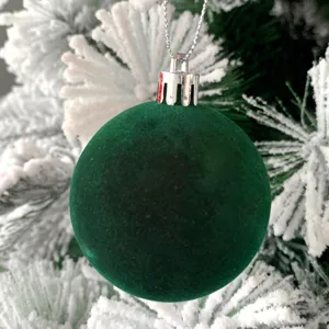 Detailaufnahme einer grünen beflockten Weihnachtskugel mit silberner Kappe für den Christbaum.