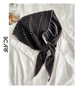 Nahaufnahme des dreieckigen Schal-Accessoires aus Baumwollmischung mit Blumenmuster, retro.