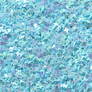 Close-up of iridescent butterfly sequins detail, sparkling craft decoration materials.