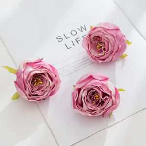 Detail shot of pink artificial rose flower heads for DIY crafts and wedding decor.