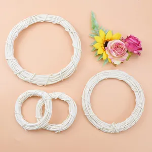 White rattan wreath rings set with artificial flowers for home door and holiday decorations style.