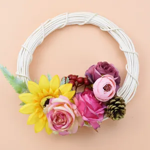 Off-white rattan wreath with artificial flowers for home decor, floral arrangement detail shot.