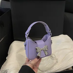 Cute purple mini crossbody bag for kids with silver bow and chain strap, stylish fashion purse.
