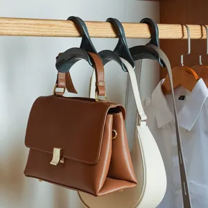 Detailed view of arched handbag hook hanging in wardrobe, perfect for bags, hats and scarves.