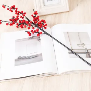 Artificial red berry branches for New Year home decoration, vivid winterberry floral arrangement.