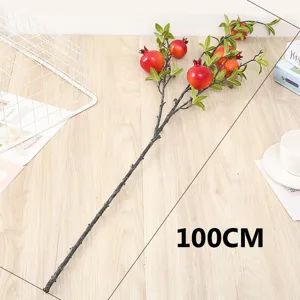 Artificial pomegranate branch detail showing red berries and green leaves for home decor.
