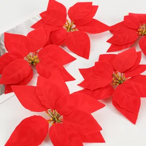Red artificial poinsettia flower heads for Christmas tree and festive home party decor.
