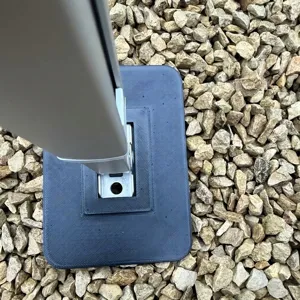 RV awning support foot pad detail shot, black heavy stabilizer base camping accessory.