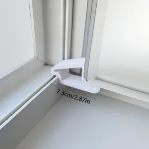 White plastic window door wedge stopper detail view, anti-pinch safety hardware part.
