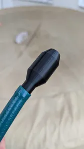 Close-up detail of black 3D printed siphon hose nozzle connector part showing smooth texture.