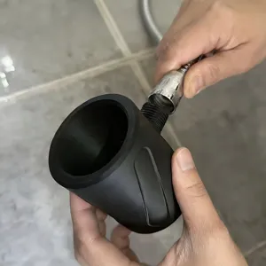 Detail view of matte black handheld shower head connection part and metal hose replacement.