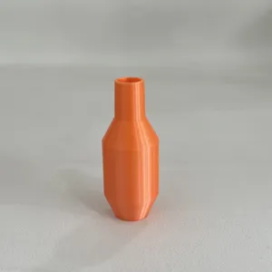 Detail view of the orange plastic siphon accessory, showcasing smooth internal flow design.