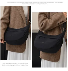 Detailed view of black nylon crescent crossbody bag, showcasing large capacity and smooth zipper.