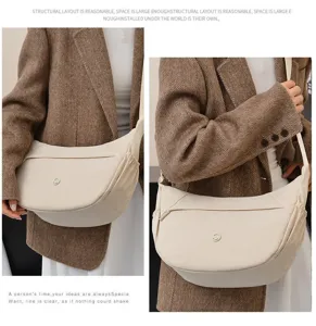 Detailed view of minimalist canvas crossbody dumpling bag showing spacious side pocket design.
