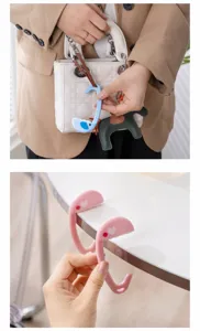 Gancho plegable multifuncional para bolsos de mesa y mochilas, diseño bonito y portátil.