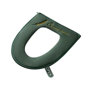 Thickened plush toilet seat cover in dark green with zipper, handle and elegant embroidery.